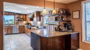 A kitchen with a large island and many cabinets.