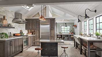 A kitchen with wooden cabinets and a metal island.