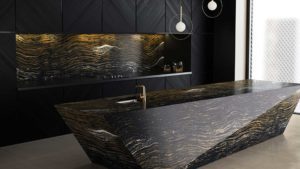 A black counter top with a sink and lights