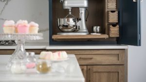 A kitchen with a counter and some cupcakes on the table
