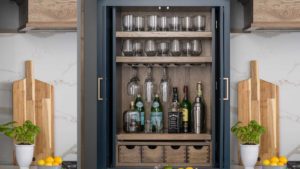 A wine cabinet with bottles and glasses on it