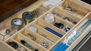 A wooden box filled with various items and tools.