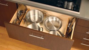 A drawer with pots and pans in it