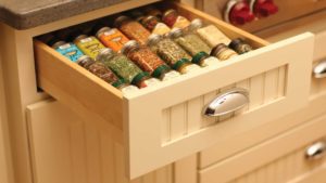 A drawer with spices in it is organized.