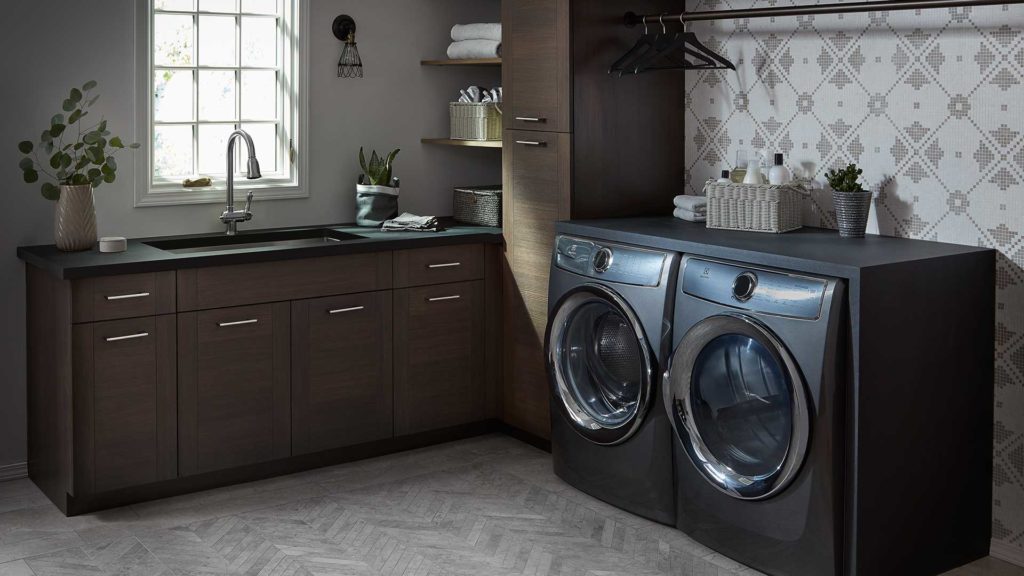 A kitchen with two washing machines and a sink