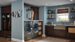 A laundry room with two machines and a sink.