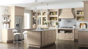 A kitchen with a large island and wooden cabinets.