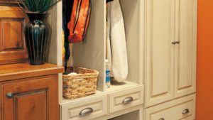A closet with two drawers and a basket on the bottom.