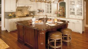 A kitchen with a large island and brown counter tops.