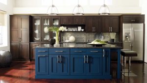 A kitchen with blue cabinets and brown cupboards