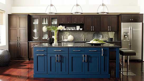 A kitchen with blue cabinets and brown cupboards