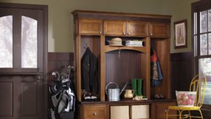 A wooden cabinet with golf clubs and bags on it.