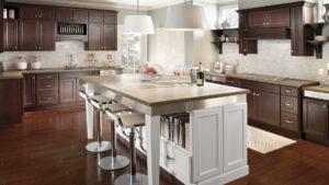 A kitchen with white cabinets and brown walls