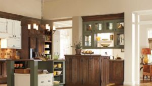 A kitchen with wooden cabinets and green island.