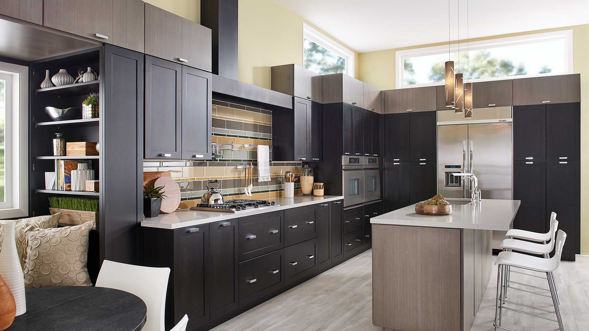 A kitchen with black cabinets and white counter tops.