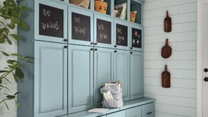 A blue cabinet with chalkboard writing on the wall.