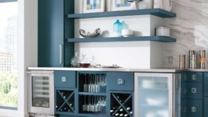 A blue and white kitchen with wine racks