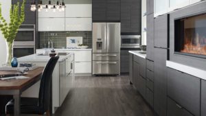 A kitchen with white cabinets and black floors