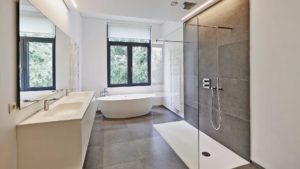A bathroom with a large walk in shower and a bathtub.