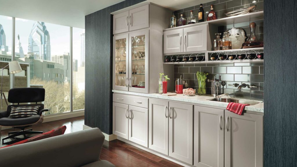 A kitchen with white cabinets and a wine rack.