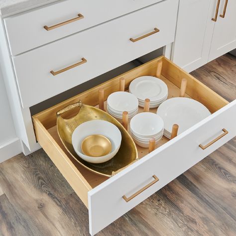 A drawer with bowls and dishes in it