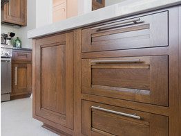 A close up of the drawers and doors on a kitchen cabinet.