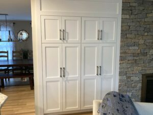 A large white cabinet with many doors and drawers.