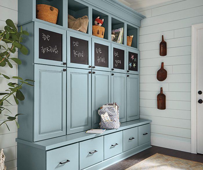 A blue cabinet with chalkboards on the front of it.