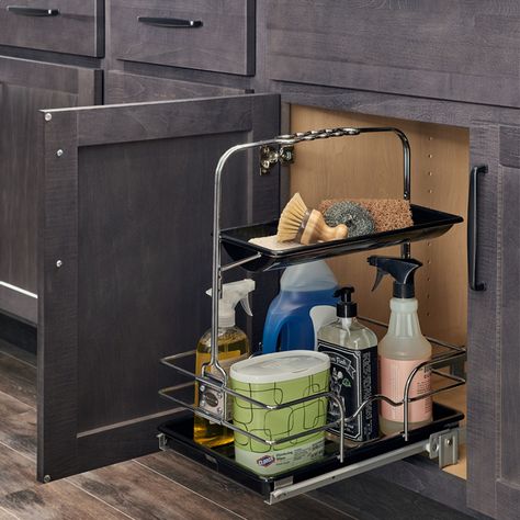 A kitchen cabinet with a metal shelf and some cleaning supplies.