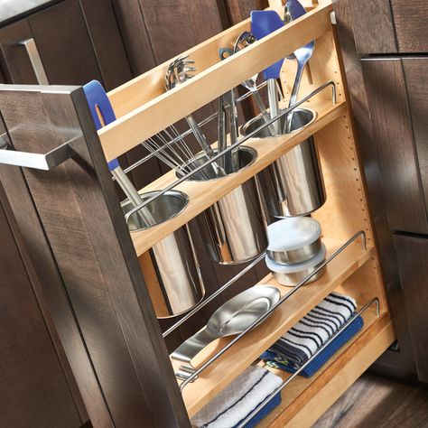 A kitchen cabinet with utensils in it