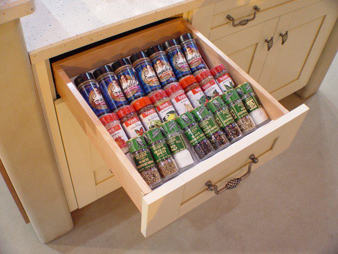 A drawer with spices in it is organized.