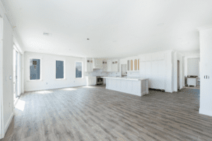 A large open room with white walls and wooden floors.