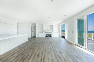 A large room with hard wood floors and white walls.