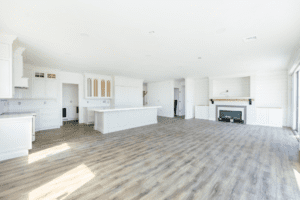 A large open floor plan with white walls and wood floors.