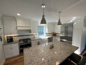 A kitchen with a large island and stainless steel appliances.