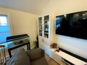 A living room with a piano and a tv