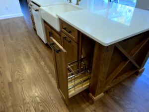 A kitchen island with sink and dishwasher in it.