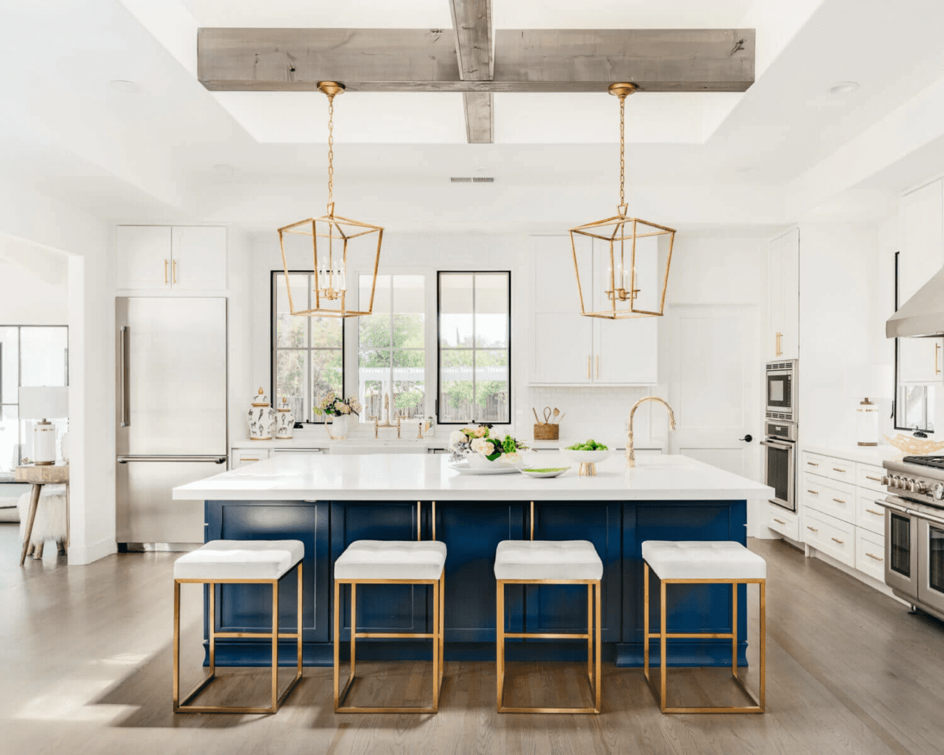 A kitchen with white walls and blue island.