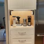 A kitchen with a coffee maker and blender in it.