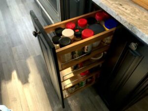 A kitchen with a drawer that has many items in it