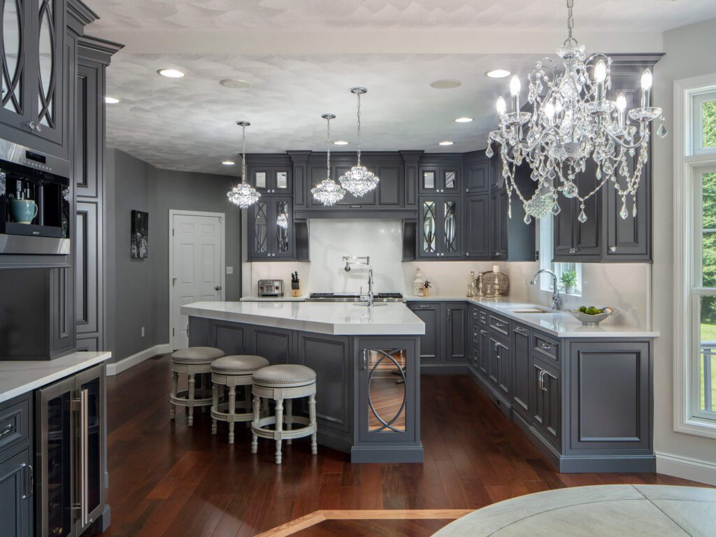 A kitchen with gray cabinets and white counters