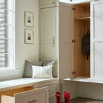 A white cabinet with two red drawers and one drawer open.