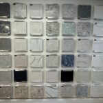 A wall of different colored marble tiles.