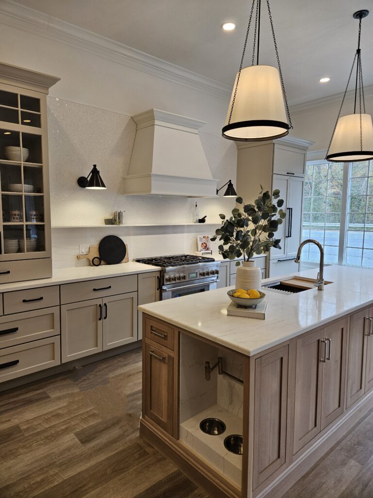 Showcasing a white kitchen with wooden floors and a stylish center island.