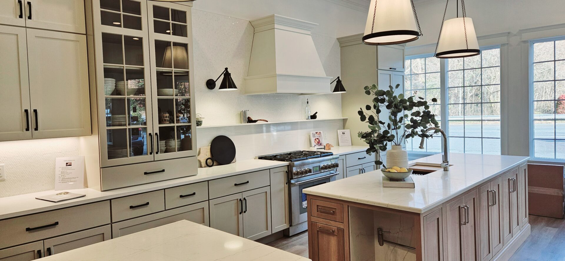 A kitchen with white cabinets and a center island.