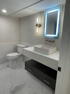 Modern bathroom with white vanity and sink.