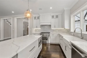 Modern kitchen with white cabinets and island.